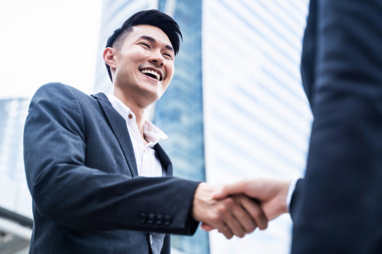 asian businessman making handshake in the city bui 2023 11 27 05 11 27 utc